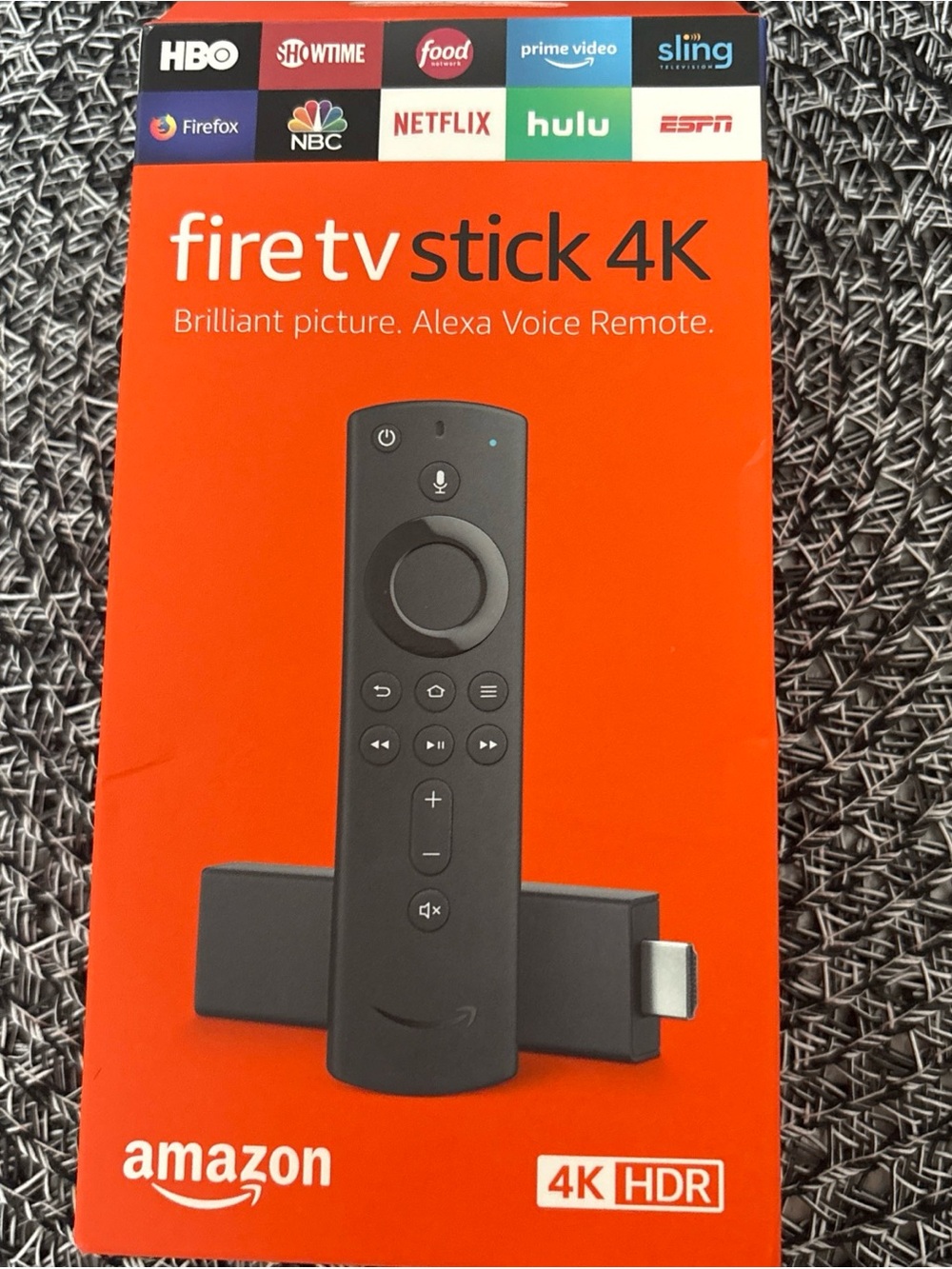 Amazon Fire TV Stick 4K Streaming Device in Bright Orange and Black